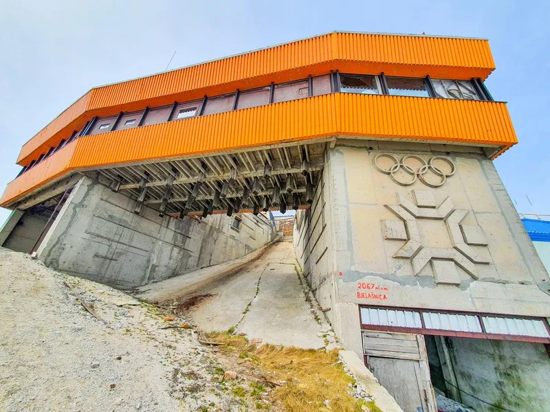 The tower at the Igman ski jumps, marked with the Olympic rings and the Sarajevo 1984 emblem